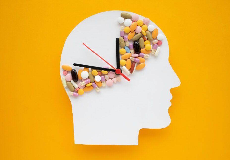 Head silhouette with pills and clock hands